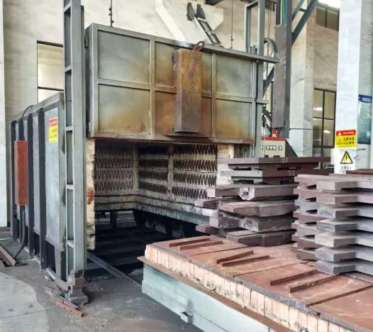 Hardened tooling plates being processed in an industrial heat-treatment furnace before wire EDM finishing
